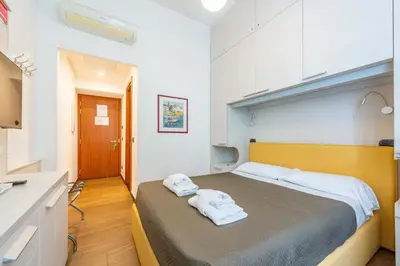 a bedroom with a large bed with towels on it at ANDENIS TIBER HOUSE in Rome