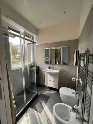 a bathroom with a shower and a toilet and a sink at Moderno bilocale con terrazzo in Rome