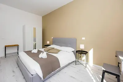a bedroom with a large bed with two towels on it at 1 Minute from San Pietro - Nicole House in Rome