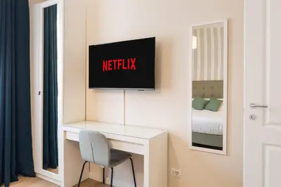 a room with a desk and a tv on a wall at AlbaDea Apartment in Rome