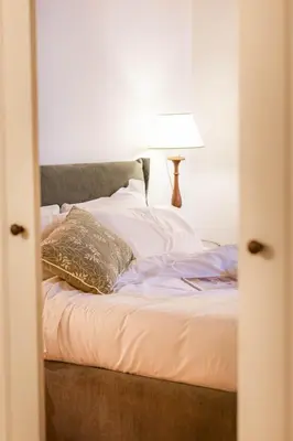 a bedroom with a bed with a lamp on it at Pantheon Luxury House - ZEN 28 in Rome