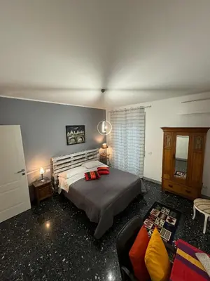 a bedroom with a large bed and a couch at Urban cosy rooms in Rome