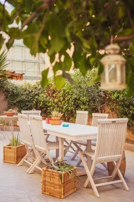 a white table and four chairs and a table and chairs at Maison Balduina in Rome