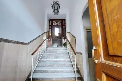 a hallway with a staircase leading to a door at Vaticano in Rome