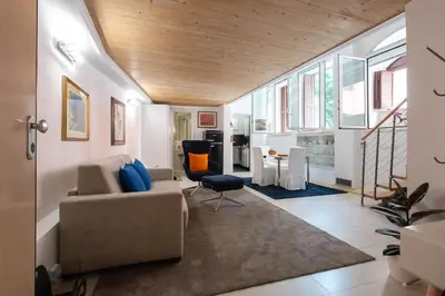 a living room with a couch and a table at Casa Bartolomeo - Loft in Trastevere in Rome