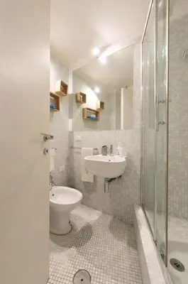 a bathroom with a sink and a toilet and a shower at Casa Bartolomeo - Loft in Trastevere in Rome