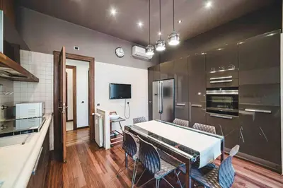 a kitchen with a table and chairs in a room at Domus trastevere 900 in Rome