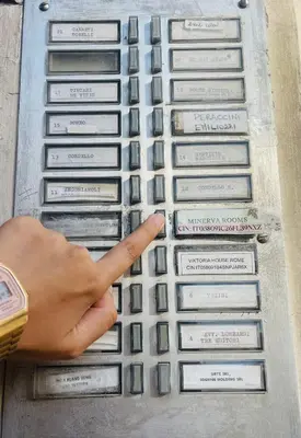 a person pointing at a keyboard with their index finger at Minerva Rooms in Rome