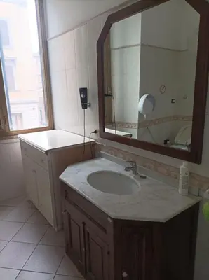 a bathroom with a sink and a mirror at Minerva Rooms in Rome
