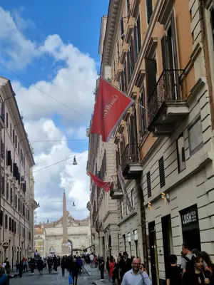 a group of people walking down a street with buildings at Corso Suite Style in Rome
