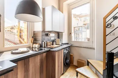 a kitchen with a washer and dryer next to a window at Palazzo Centini Toni - Rome with style in Rome