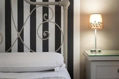 a bedroom with a bed and a lamp on a table at Residenza Ottaviani Roma in Rome
