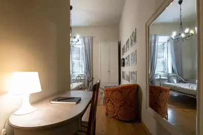 a room with a desk with a lamp and a mirror at Residenza Ottaviani Roma in Rome