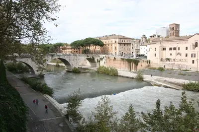 a bridge over a river in a city at Maison della Luce in Rome