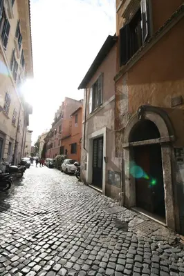 a cobblestone street in a city with buildings at Maison della Luce in Rome