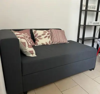 a black couch with pillows on it in a room at Dolcevita San Lorenzo luxury in Rome