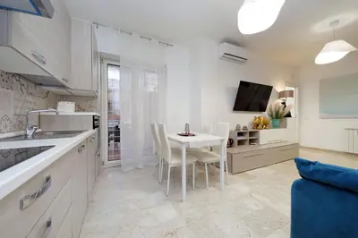 a kitchen and dining room with a table and chairs at Lovely apartment with terrace near the Vatican in Rome