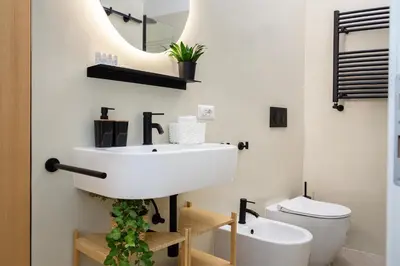 a bathroom with a sink and a toilet at Domus Opimiani in Rome