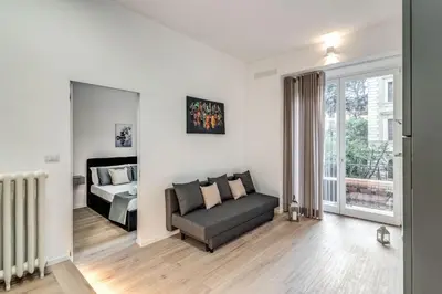 a living room with a couch and a bed at Vatican Portrait Suites in Rome