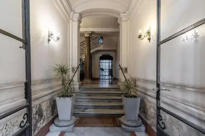 a hallway with stairs and potted plants at Vatican Portrait Suites in Rome