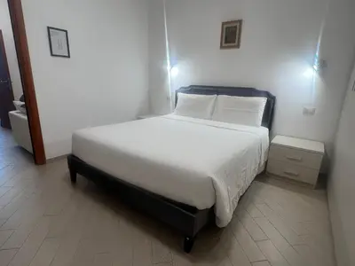 a bedroom with a bed with white sheets and pillows at Casa Gemelli in Rome