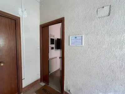 a hallway with a door and a sign on a wall at Casa Gemelli in Rome