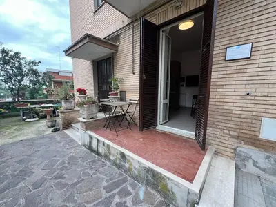 a porch of a house with a table and a patio at Casa Gemelli in Rome