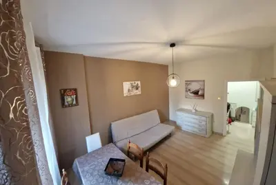 a living room with a couch and a table at Holiday home Telese Roma in Rome