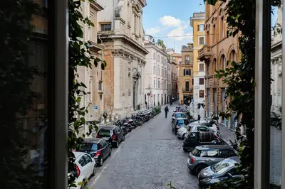 a city street with cars parked on the side of the road at La Casetta a Monti in Rome