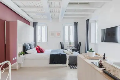 a bedroom with a king sized bed and a sink at La Casetta a Monti in Rome