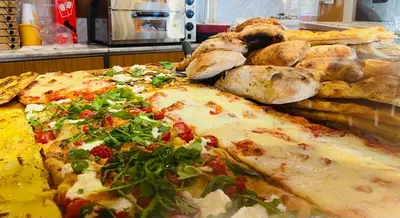a large pizza sitting on top of a table at Large Garden in Rome