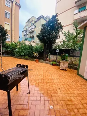 a brick courtyard with a bench in a building at Large Garden in Rome