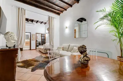 a living room with a table and a couch at GIULIO CESARE DELUXE - Spanish Step RomeDreamHome in Rome