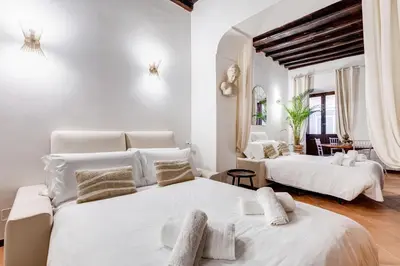 two beds in a room with white walls at GIULIO CESARE DELUXE - Spanish Step RomeDreamHome in Rome