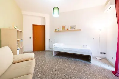 a white room with a bed and a couch at Casa Di Cristina in Rome
