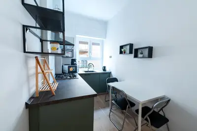 a kitchen with a counter and a table with chairs at Casa Di Cristina in Rome