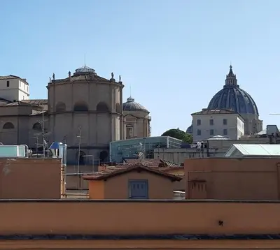 a group of buildings with domes in the background at Sun's House in Rome