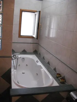 a bath tub in a bathroom with a window at Sun's House in Rome