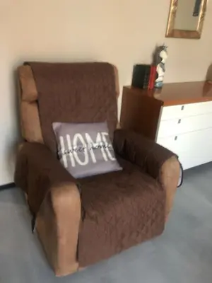 a brown chair with a pillow on top of it at Interno 18 - appartamento a San Giovanni in Rome
