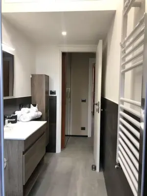 a bathroom with a sink and a hallway with a door at Interno 18 - appartamento a San Giovanni in Rome