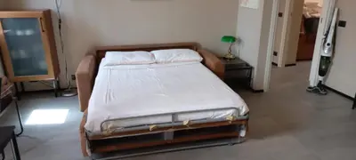 a bedroom with a bed with white sheets on it at Interno 18 - appartamento a San Giovanni in Rome