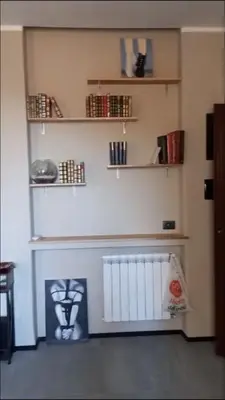 a room with shelves and a bench on the wall at Interno 18 - appartamento a San Giovanni in Rome