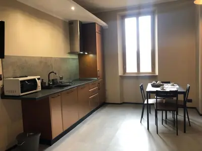 a small kitchen with a table and a microwave at Interno 18 - appartamento a San Giovanni in Rome
