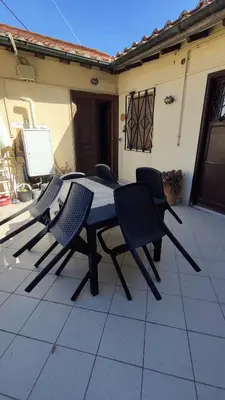 a table and chairs sitting on a patio at Attic Roof Oasi Vaticana in Rome