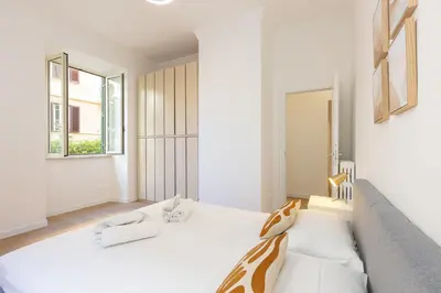 a white room with a bed and a couch at Faleria by Rental in Rome in Rome