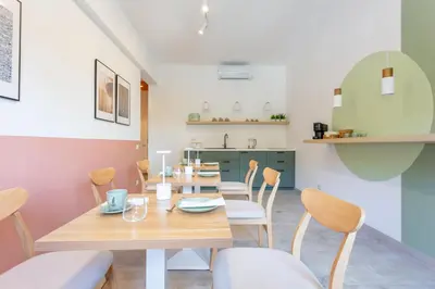 a dining room with a wooden table and chairs at 633 APPIA DESIGN ROOM in Rome