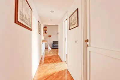 a hallway of a home with white walls and wood floors at Piazza Navona - Roma Centro Storico in Rome