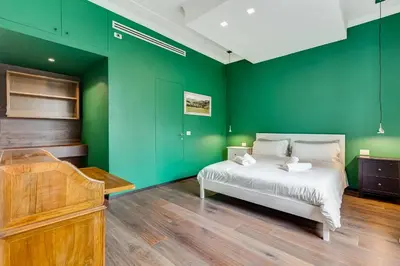 a bedroom with green walls and a bed and a piano at Music Bridge Apartment in Rome