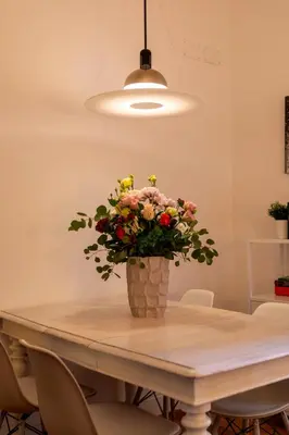 a vase of flowers sitting on top of a table at Casa Cecilia Roma in Rome