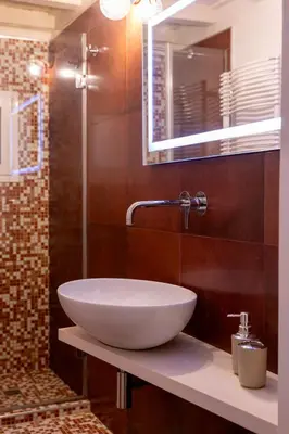 a bathroom with a white bowl sink on a counter at Casa Cecilia Roma in Rome